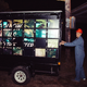 Krewe member Transceiver pulls out his creation — an homage to the advertising billboard trucks that roll through New Orleans. He used 48 monitors donated by a private school, 48 raspberry pi computers, and the program info-beamer — which runs off his cell phone — to change the content in real time, so the videos can comment on what’s nearby. Photo: Akasha Rabut.